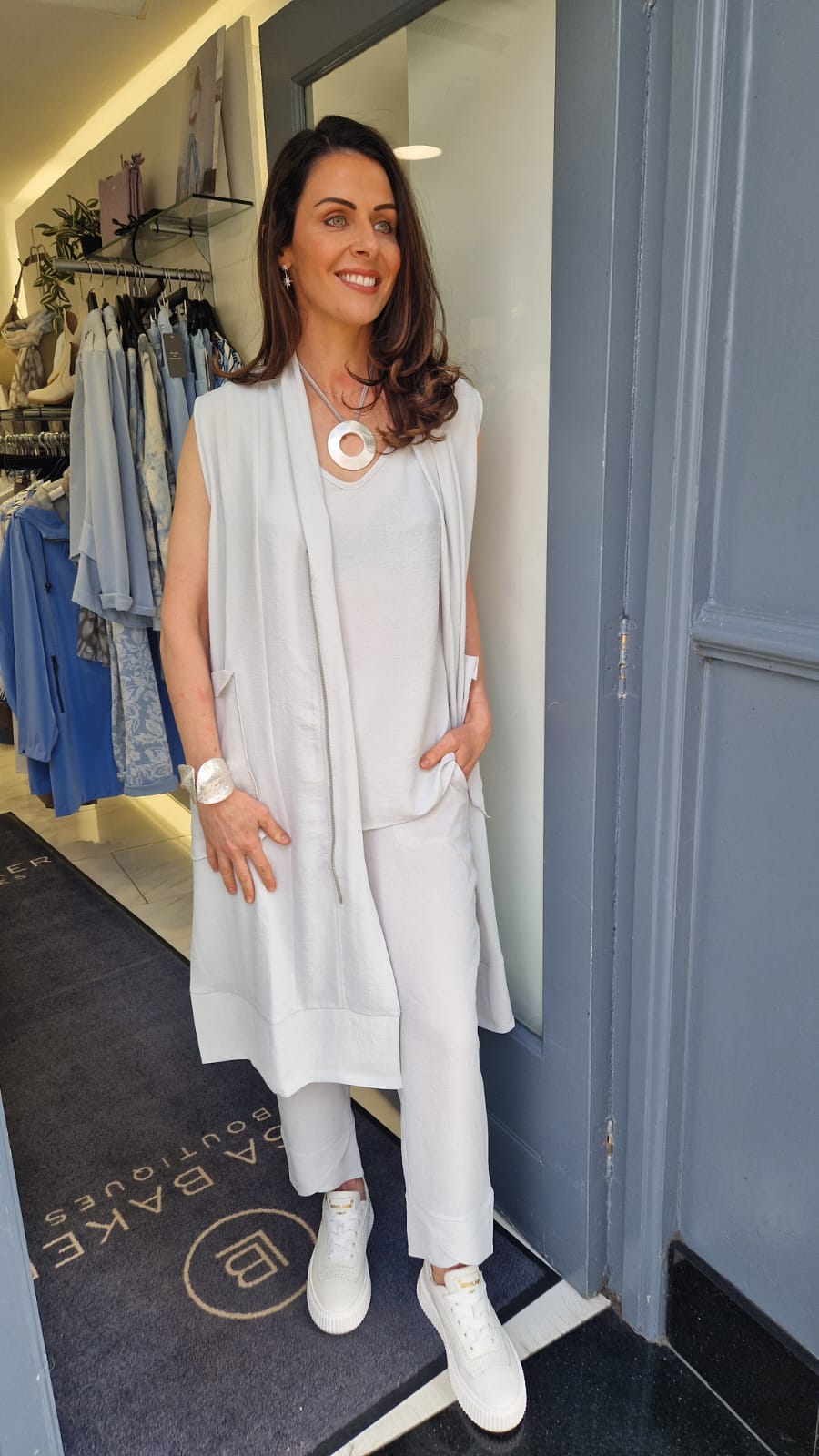 I.NCO sleeveless duster coat with zip up detail and pockets in light grey. Product code 1115-29 (front)